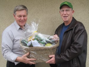 Dale Lyons (left) accepts on behalf of granddaughter Cloe Moreton from Hamilton a wooden model of a John Deere tractor handcrafted by Ross Patterson (R). Rosemary Lorie from Westport won second prize of one hundred dollars, and Marg & Bruce Graham from Newboro won third prize of $50.00. This draw raised over a thousand dollars that will go directly towards projects for the youth in our community. The Westport Lions' Club wishes to thank the community for their support.